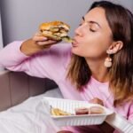 जल्दी-जल्दी खाना खाते हुए व्यक्ति